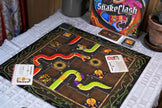Snake Clash tile laying board game box with board and game cards
