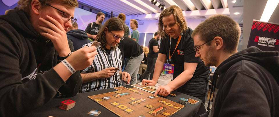 Marius Miliauskas showing people how to play Snake Clash board game